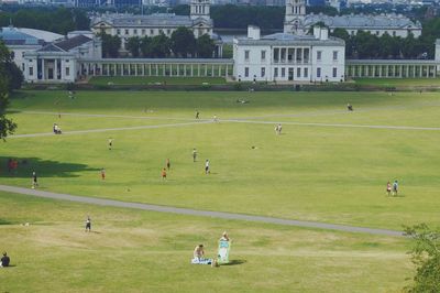 People walking on grassy field