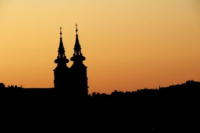 Silhouette of building against sky during sunset