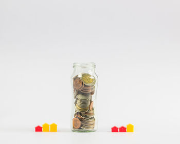 Close-up of coins on glass against white background