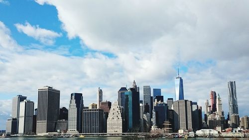 Cityscape against cloudy sky