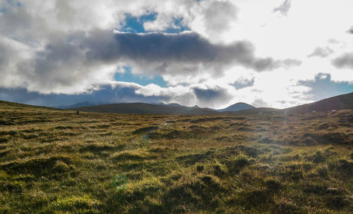 Scenic view of mountains against cloudy sky