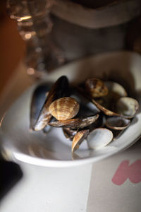 High angle view of shells in plate on table