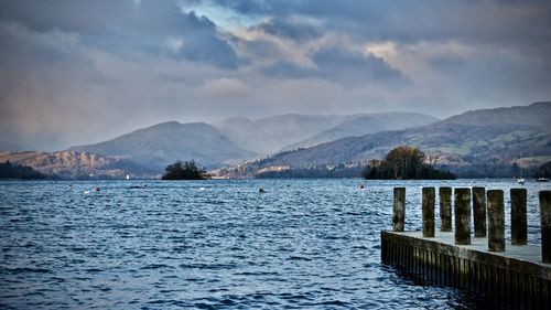 Scenic view of lake and mountains against sky