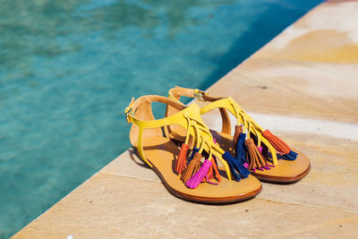High angle view of shoes on swimming pool