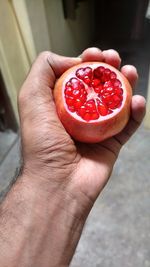 Close-up of hand holding strawberries