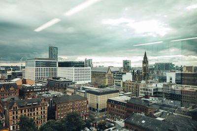 Cityscape against cloudy sky