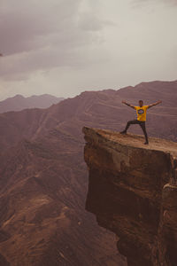 Rear view of man standing on mountain