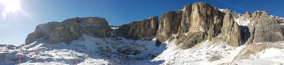 Low angle view of snowcapped mountains during sunny day