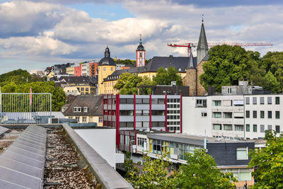 Buildings in town against sky