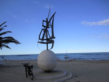 Lifeguard hut on beach against clear blue sky