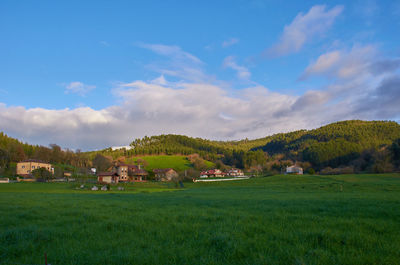 Scenic view of farm against sky