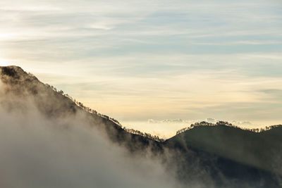 Scenic view of mountain against cloudy sky