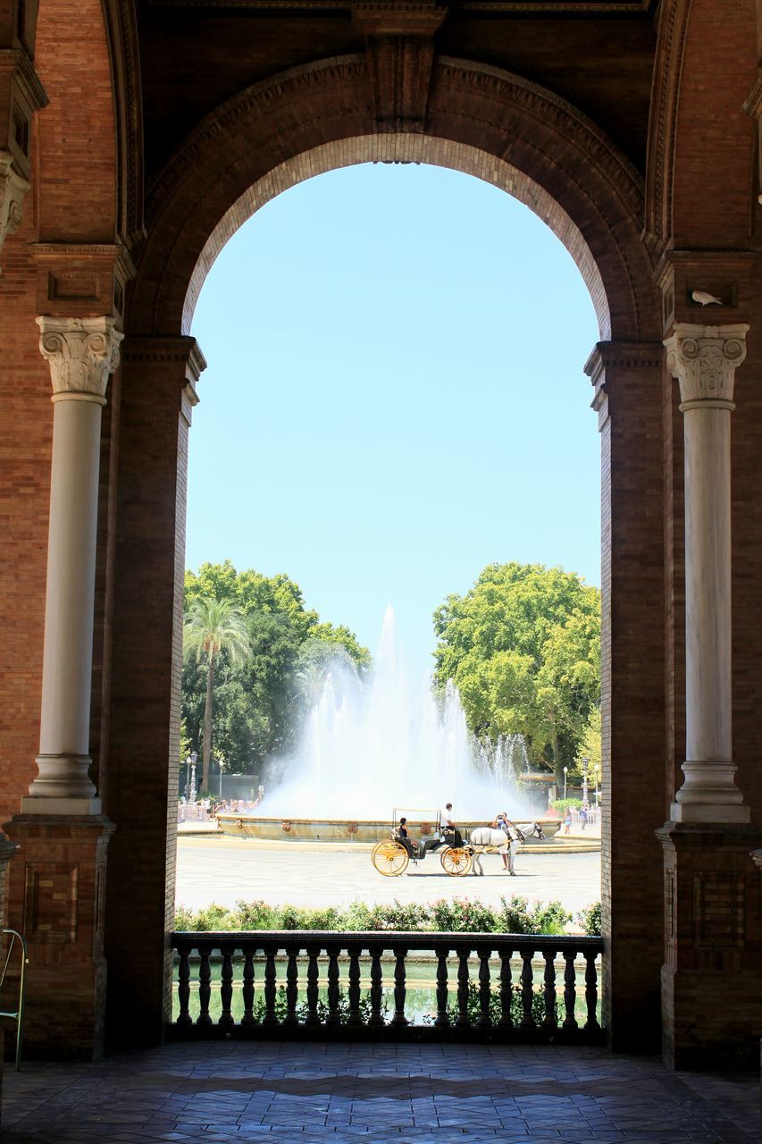 arch, fountain, architecture, travel, history, travel destinations, water, splashing, built structure, tourism, day, outdoors, tree, no people, sky, ancient civilization