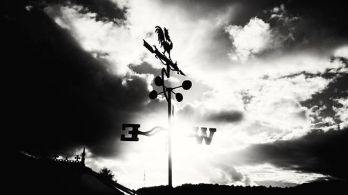 Low angle view of street light against cloudy sky