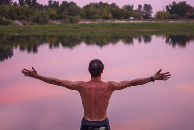 Rear view of woman standing in lake