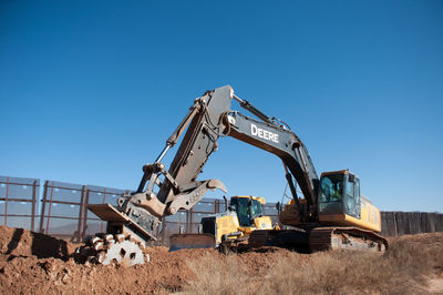 Construction site on field against clear blue sky