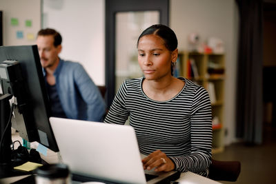 People working on table in office