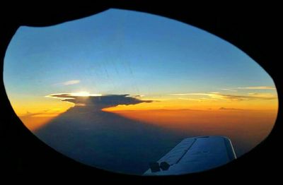 Cropped image of airplane wing over landscape