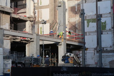 People working at construction site in city