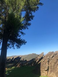 Scenic view of mountains against clear blue sky