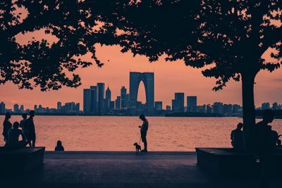 Silhouette of buildings against sky during sunset