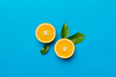 Directly above shot of oranges on blue background