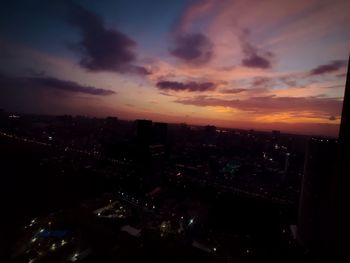 High angle view of illuminated buildings against sky during sunset