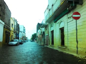 Narrow road leading towards buildings