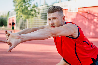 Side view of young man exercising at park