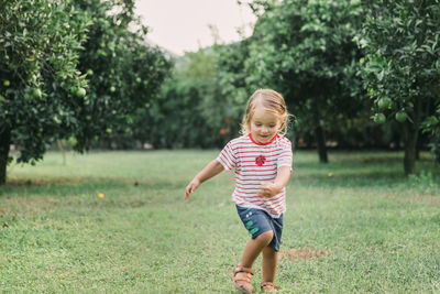 Cute girl running at orchard 