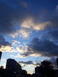 Low angle view of silhouette buildings against sky