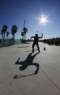 Silhouette of woman on sunny day