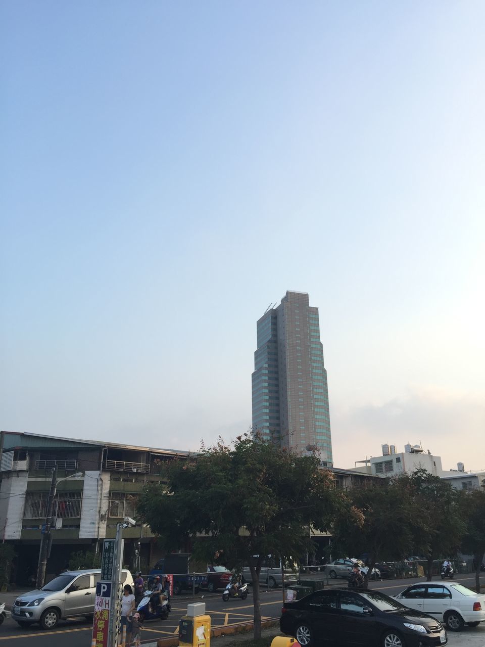 building exterior, architecture, built structure, tree, city, tall - high, tower, sky, low angle view, clear sky, skyscraper, travel destinations, city life, famous place, day, building, travel, incidental people, outdoors