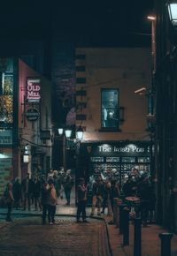 People on street in city at night