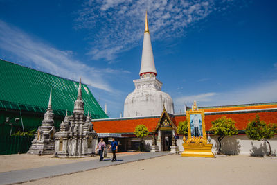 Group of people outside temple against building