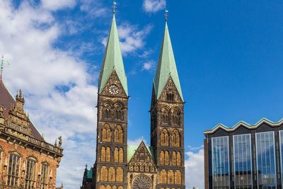 Low angle view of buildings against blue sky