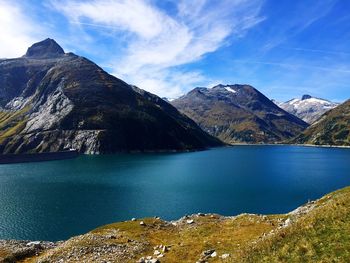 Calm lake with mountains in background