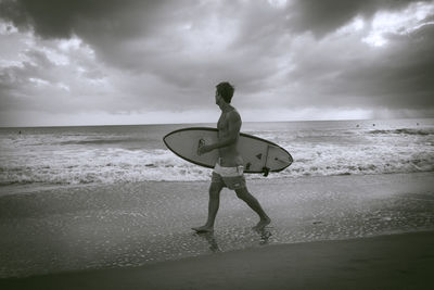Full length of man on beach against sky