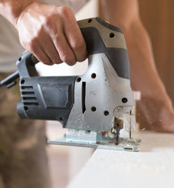 Close-up of man working on machine