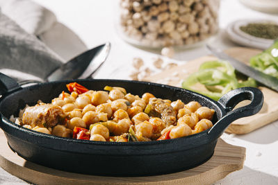 Close up still life of chickpea stew with vegetables, herbs and beef