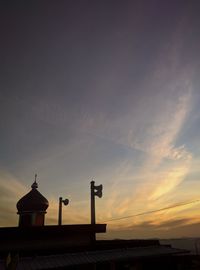 Low angle view of silhouette building against sky during sunset