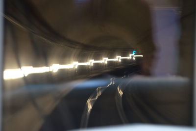 Illuminated tunnel at night