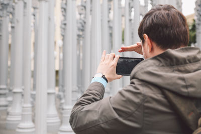 Rear view of woman photographing