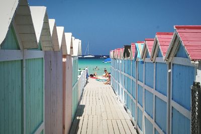 Beach huts against clear sky