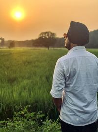 Rear view of man standing on field