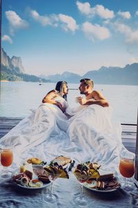 Couple relaxing by sea