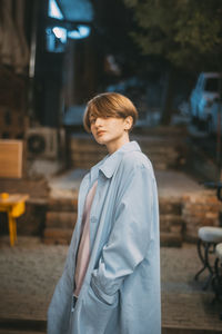Woman looking away while standing on seat