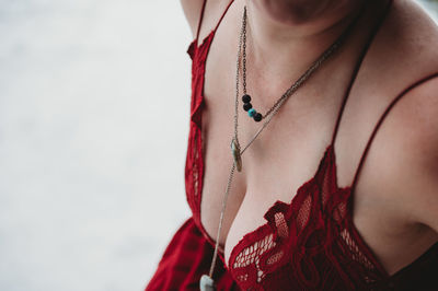 Midsection of sensual woman wearing necklace