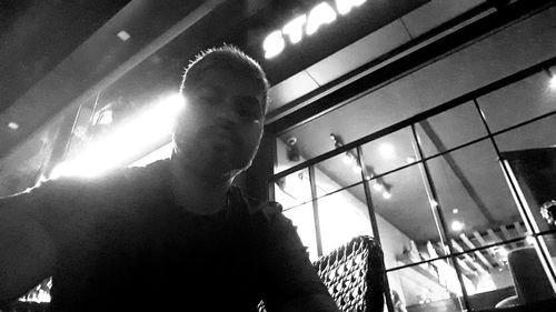 Low angle view of man seen through window