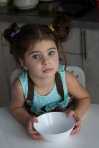 High angle view of cute girl sitting at home